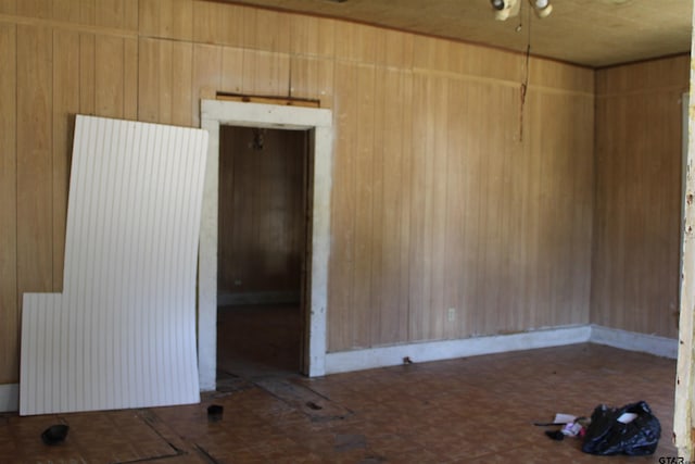 empty room featuring wooden walls