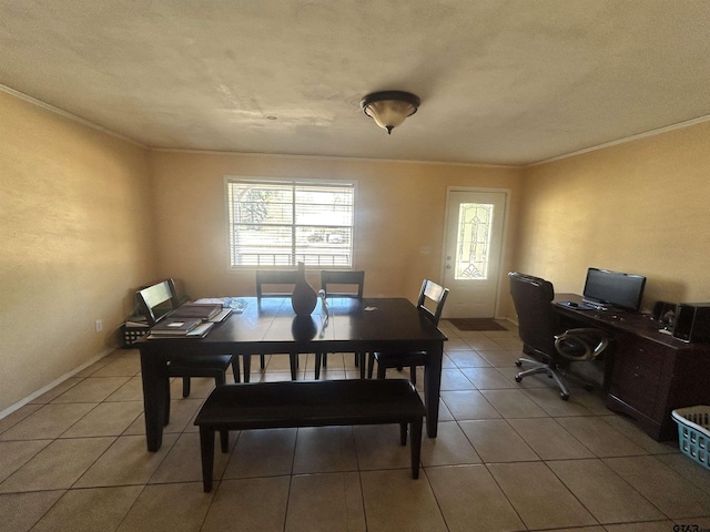 dining area featuring light tile patterned floors, baseboards, and ornamental molding