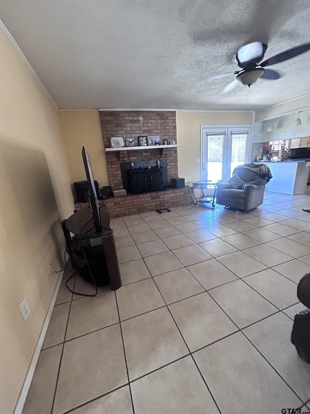 unfurnished living room featuring light tile patterned floors, a textured ceiling, ceiling fan, and a fireplace