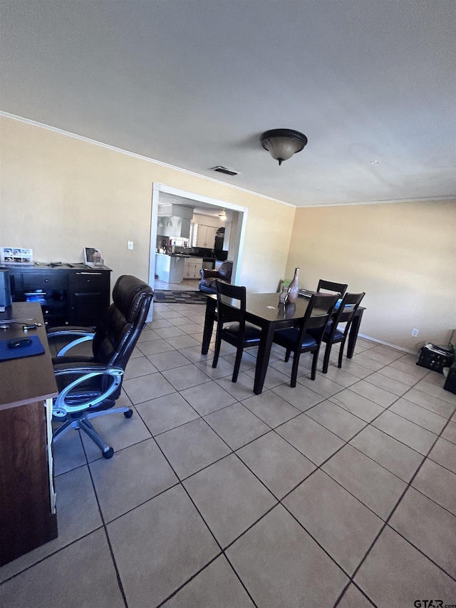 dining space featuring light tile patterned floors, visible vents, and ornamental molding