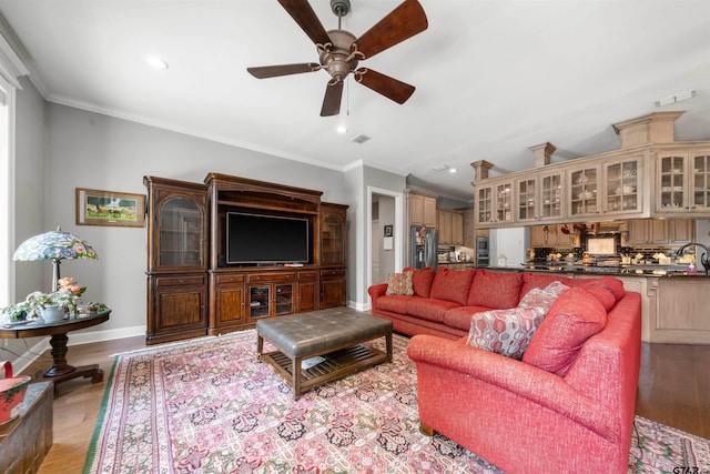 living room with ornamental molding, sink, ceiling fan, and light hardwood / wood-style flooring