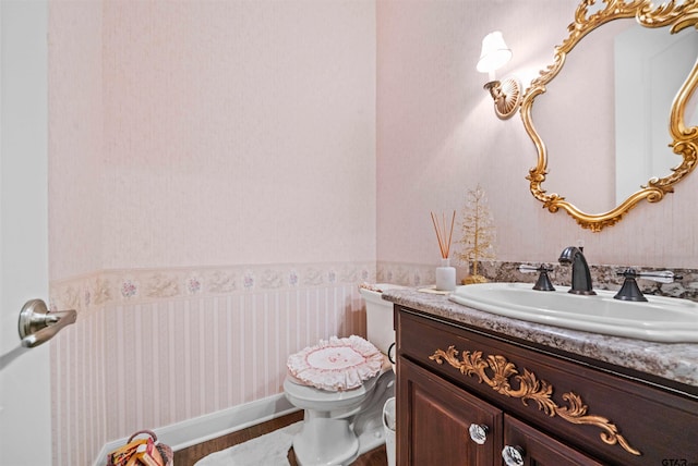 bathroom featuring toilet and vanity