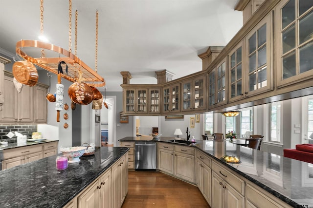 kitchen featuring stainless steel dishwasher, dark wood-type flooring, pendant lighting, and tasteful backsplash