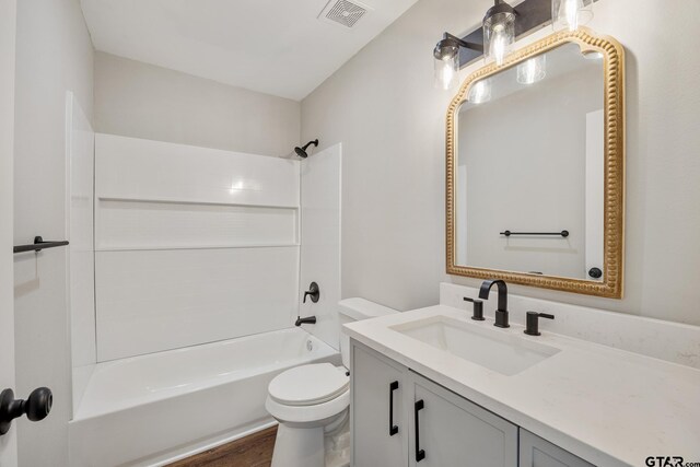 bathroom featuring shower / bathtub combination, toilet, wood finished floors, vanity, and visible vents