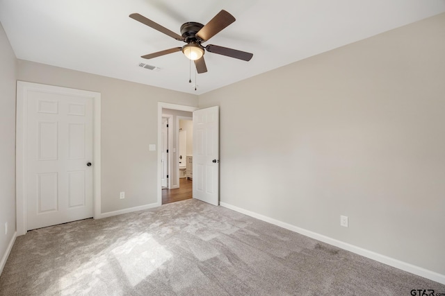 unfurnished bedroom with a ceiling fan, carpet, visible vents, and baseboards