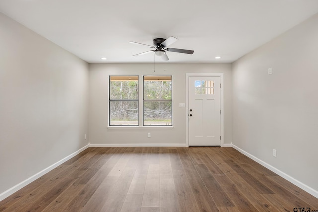 interior space with a ceiling fan, baseboards, wood finished floors, and recessed lighting