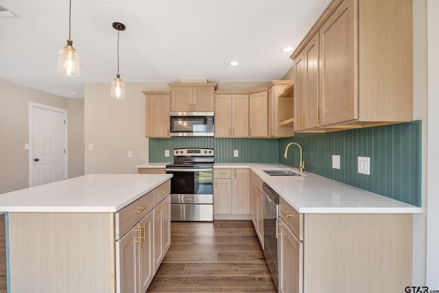 kitchen featuring visible vents, appliances with stainless steel finishes, wood finished floors, light brown cabinets, and a sink