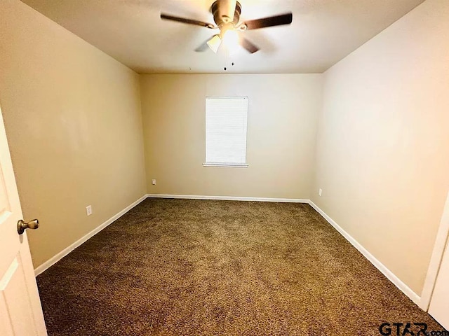 spare room with a ceiling fan, carpet flooring, and baseboards