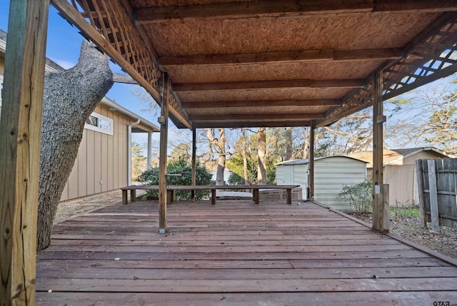 wooden terrace featuring a shed