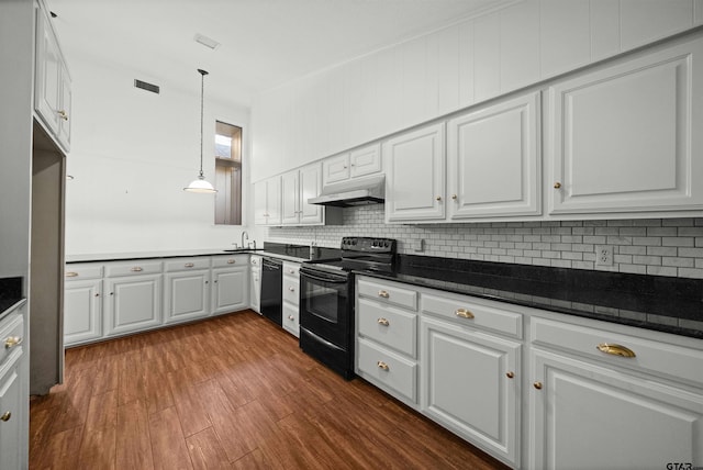 kitchen featuring sink, white cabinetry, hanging light fixtures, dark stone countertops, and black appliances