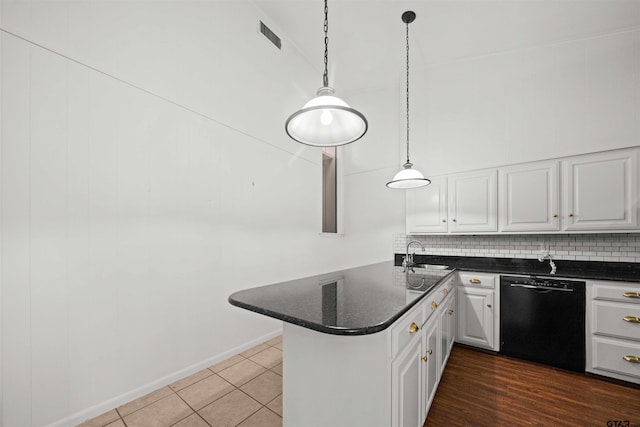 kitchen with sink, white cabinetry, decorative light fixtures, dishwasher, and kitchen peninsula