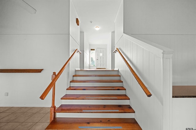 staircase featuring tile patterned flooring