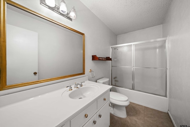 full bathroom featuring tile patterned floors, toilet, shower / bath combination with glass door, a textured ceiling, and vanity