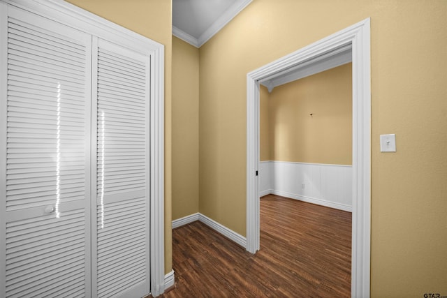 hall with ornamental molding and dark hardwood / wood-style floors