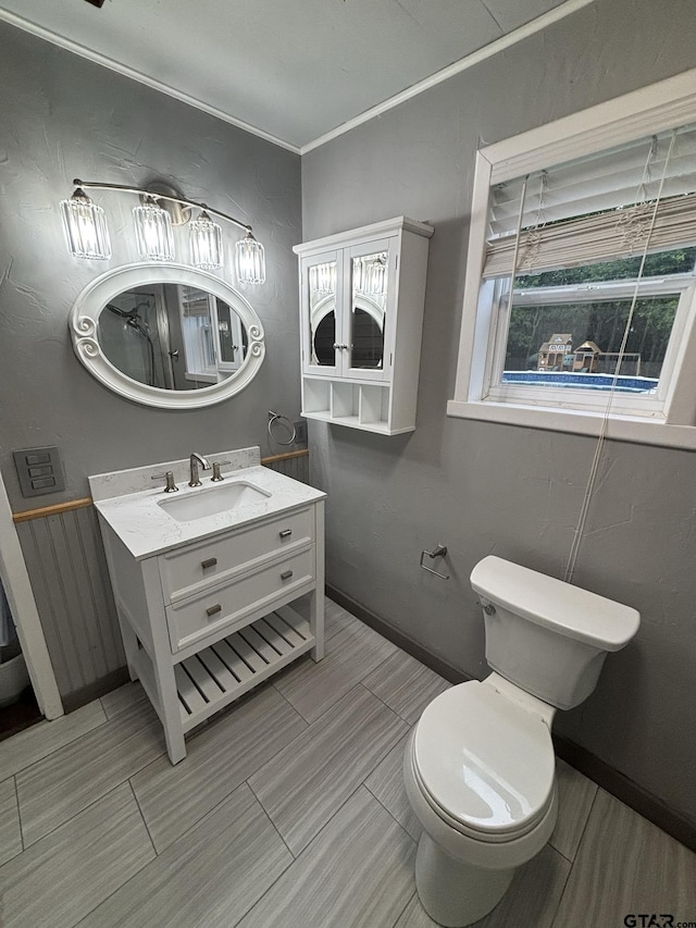 606 Glazner St, Hawkins, TX 75765 - bathroom featuring vanity, toilet, wood finish floors, and baseboards