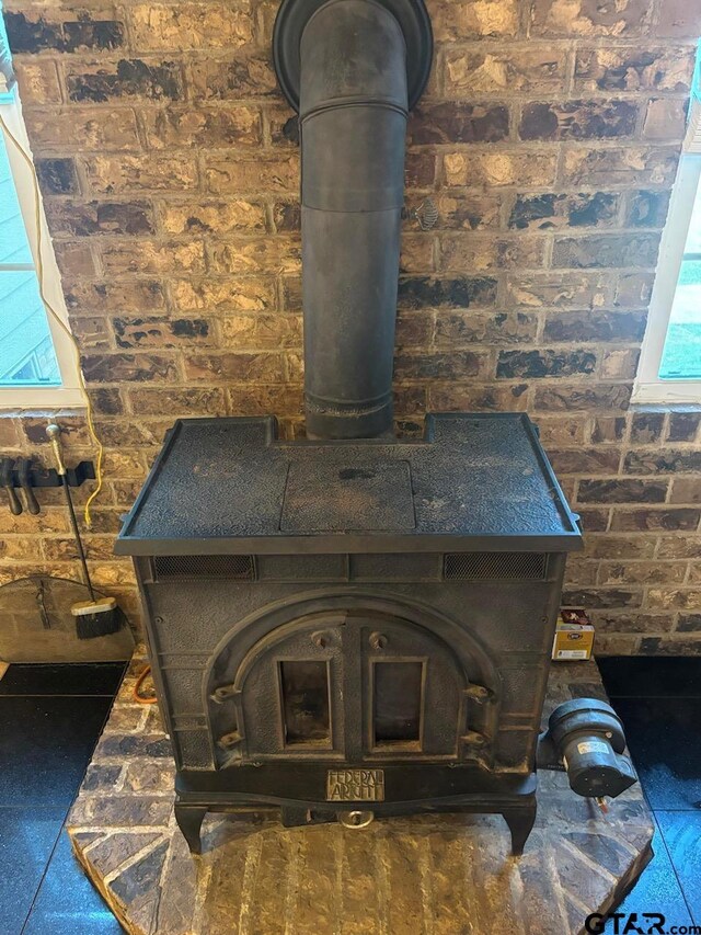 606 Glazner St, Hawkins, TX 75765 - detailed view of brick wall and a wood stove