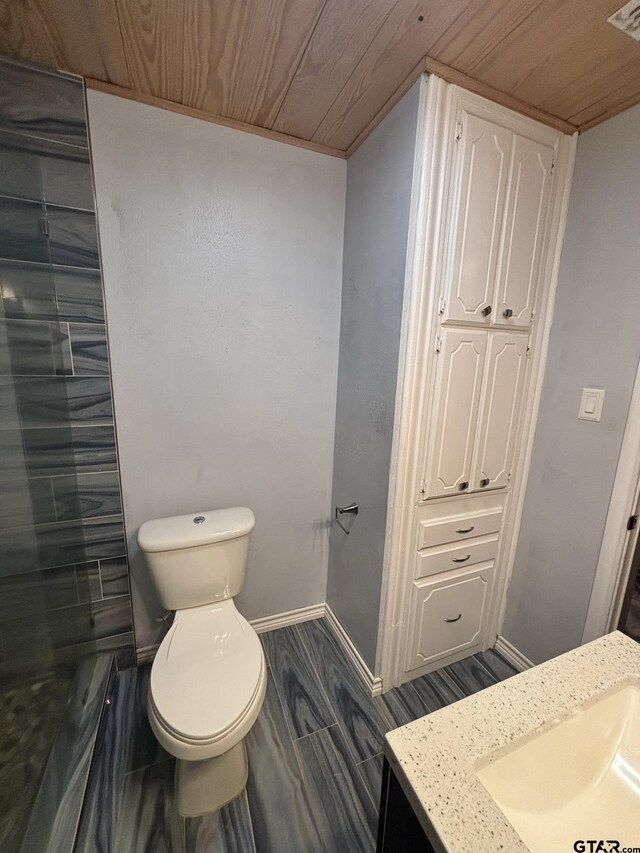 606 Glazner St, Hawkins, TX 75765 - bathroom with vanity, toilet, wooden ceiling, and baseboards