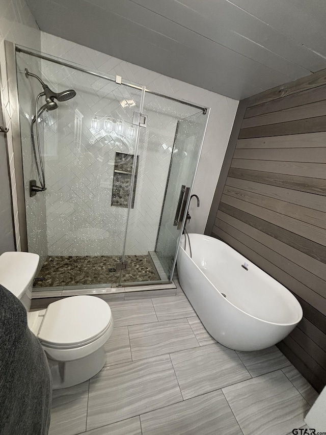 606 Glazner St, Hawkins, TX 75765 - bathroom with a shower stall, a soaking tub, wooden walls, and toilet