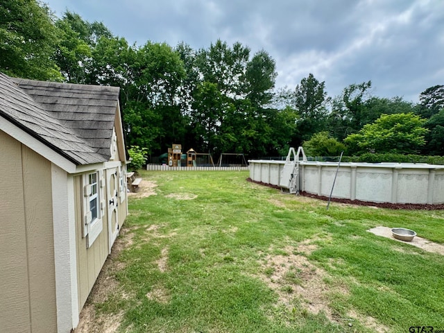 606 Glazner St, Hawkins, TX 75765 - view of green lawn featuring an outdoor pool and view of scattered trees