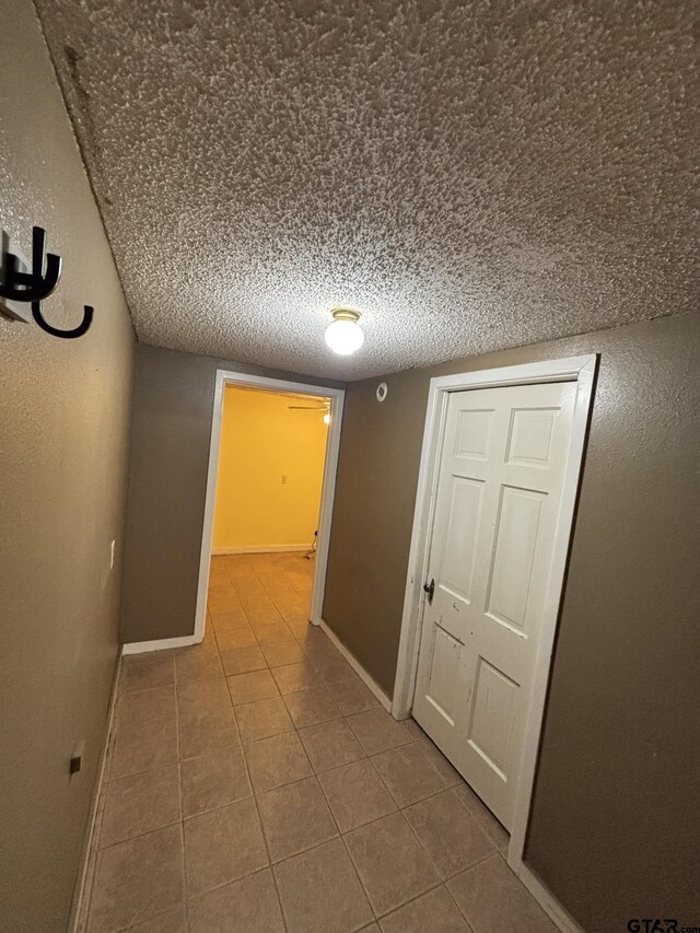 606 Glazner St, Hawkins, TX 75765 - hallway with tile patterned floors and baseboards