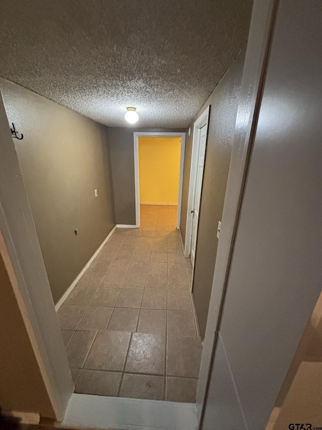 606 Glazner St, Hawkins, TX 75765 - corridor featuring tile patterned flooring, baseboards, and a textured ceiling
