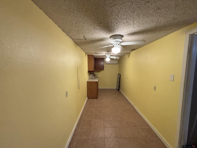 606 Glazner St, Hawkins, TX 75765 - finished basement featuring tile patterned floors, baseboards, a textured ceiling, and a ceiling fan