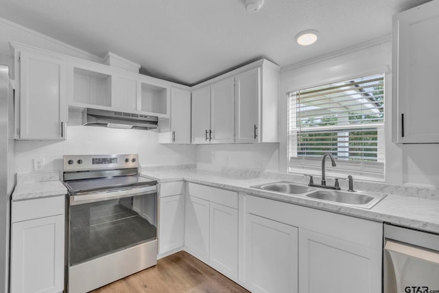 441 N Hill, Tyler, TX 75706 - kitchen with stainless steel appliances, wall chimney range hood, open shelves, white cabinetry, and a textured ceiling