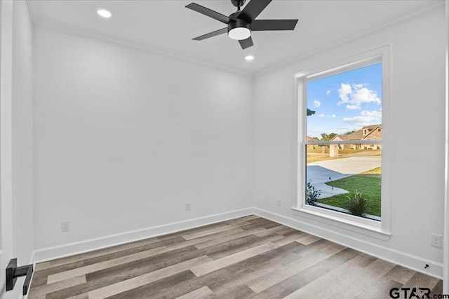 empty room featuring ceiling fan, crown molding, and light hardwood / wood-style flooring