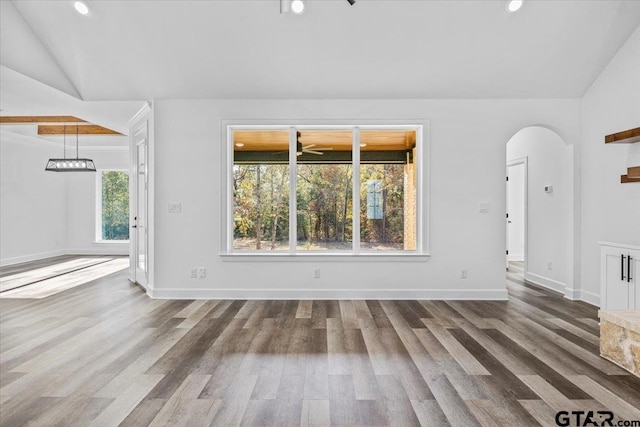 unfurnished living room featuring wood-type flooring and vaulted ceiling