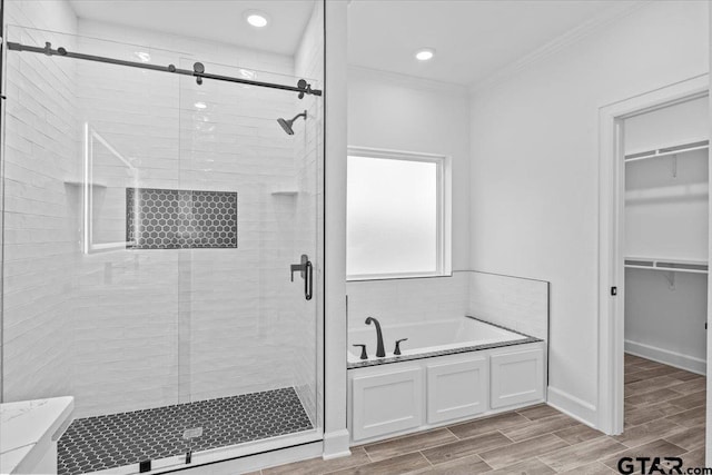 bathroom featuring shower with separate bathtub and ornamental molding