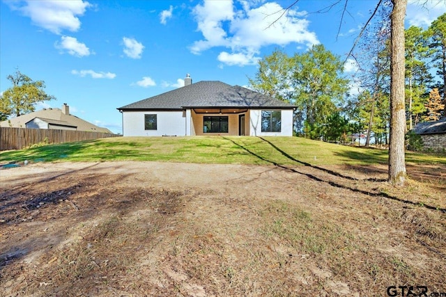 rear view of house with a lawn