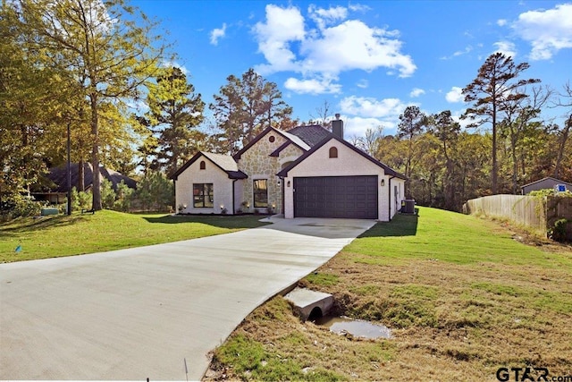 view of front facade with a garage and a front lawn