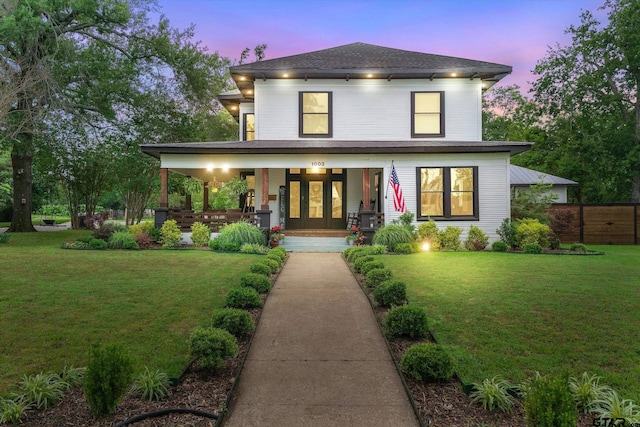 view of front of house featuring a porch and a lawn