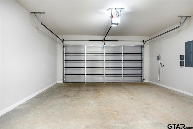 garage with a garage door opener and electric panel