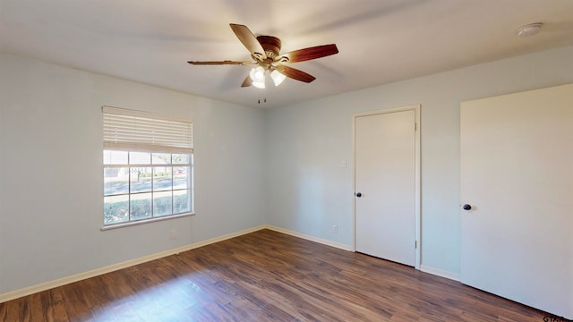 spare room with ceiling fan and dark hardwood / wood-style floors