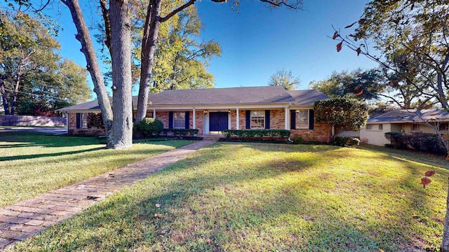 ranch-style house featuring a porch and a front lawn