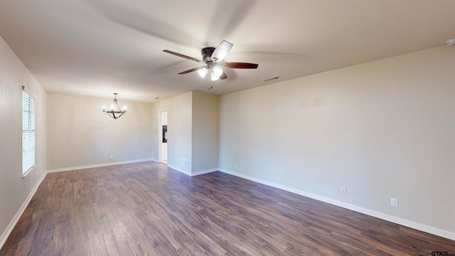 unfurnished room featuring ceiling fan with notable chandelier and dark hardwood / wood-style flooring