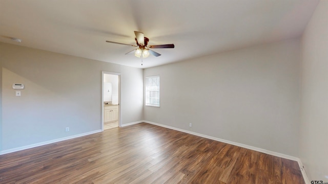 empty room with ceiling fan and dark wood-type flooring