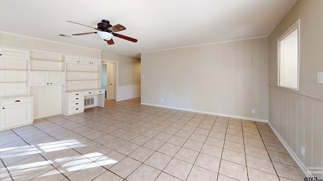 unfurnished living room featuring ceiling fan, crown molding, and light tile patterned floors