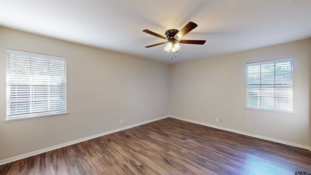 spare room with ceiling fan and dark wood-type flooring