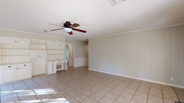 interior space featuring ceiling fan, crown molding, and built in shelves