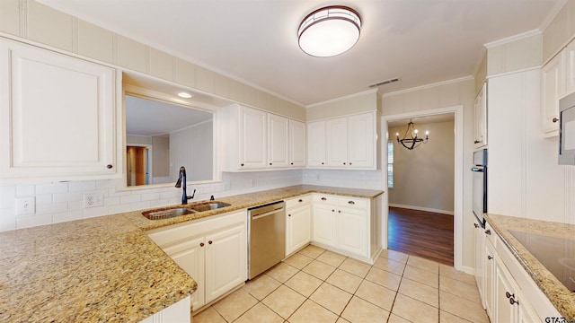 kitchen featuring appliances with stainless steel finishes, light stone counters, ornamental molding, sink, and white cabinetry