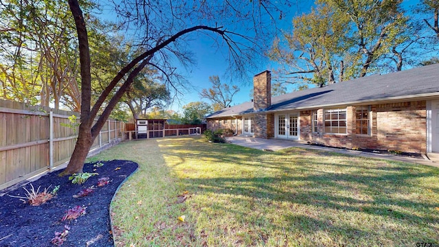 view of yard with french doors and a patio area