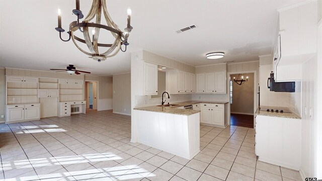 kitchen featuring white cabinetry, sink, light stone counters, kitchen peninsula, and ceiling fan with notable chandelier