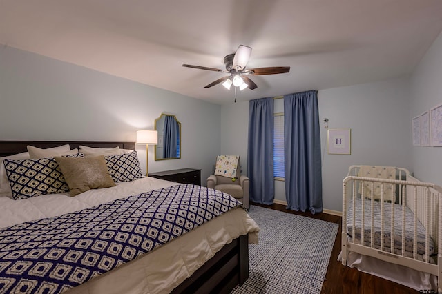 bedroom featuring ceiling fan and dark hardwood / wood-style flooring