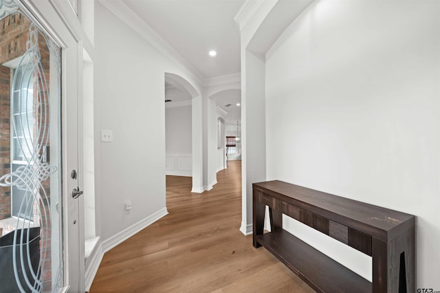 corridor featuring light hardwood / wood-style floors and ornamental molding