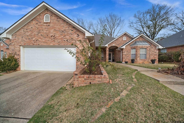 view of front of house with a front yard and a garage