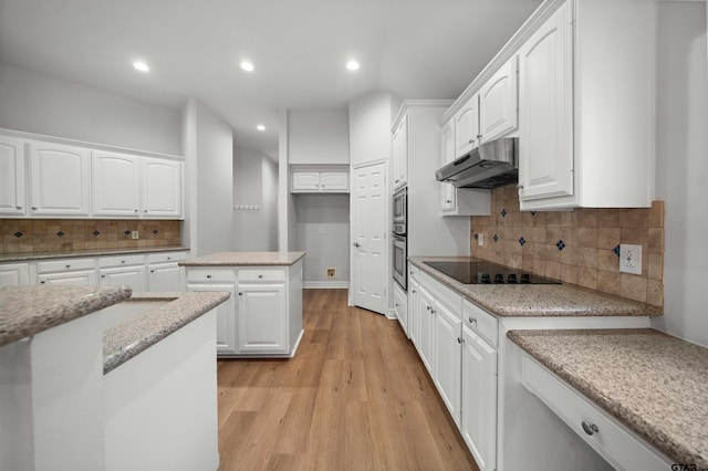 kitchen with backsplash, white cabinets, black electric cooktop, light hardwood / wood-style floors, and light stone counters