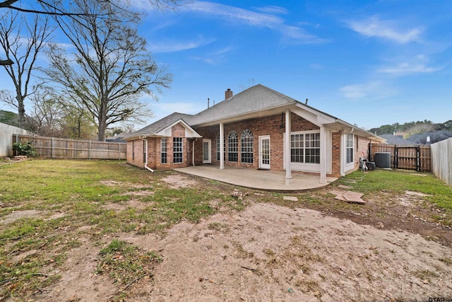 back of property featuring a yard, a patio, and central AC