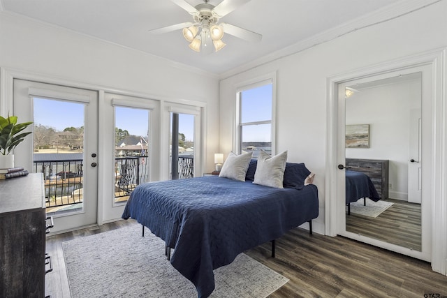 bedroom featuring multiple windows, crown molding, dark hardwood / wood-style floors, and french doors